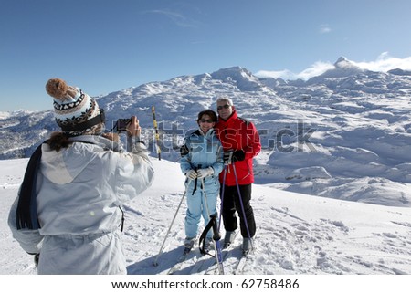 Senior man and women being photographed in snow