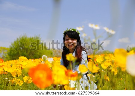 japanese young lady with flower crown in flower garden