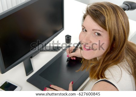 pretty young female designer using graphics tablet