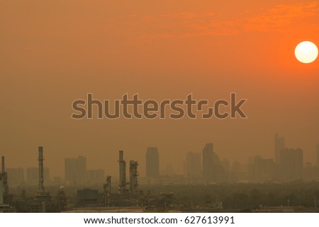 Oil refinery in metropolis on sunset.