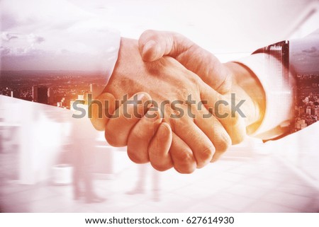 Close up of handshake on abstract city background. Double exposure. Team work concept Royalty-Free Stock Photo #627614930