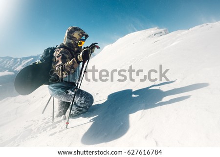 sportsman go with snowboard equipment on the snow hill