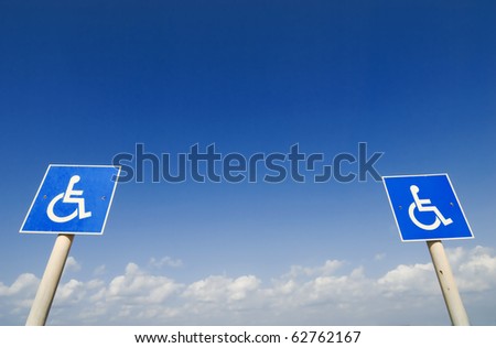 Closeup of handicapped parking place sign over blue sky