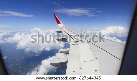 Aircraft wing against bluesky from its windows,picture frame.