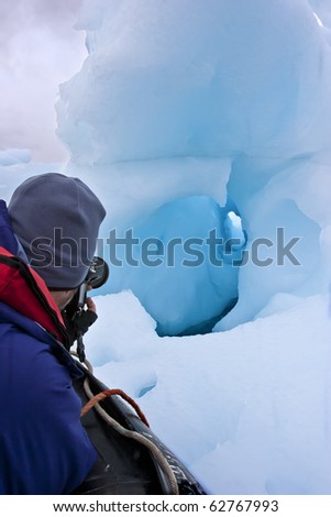 retired man traveling and taking picture of icebergs, greenland