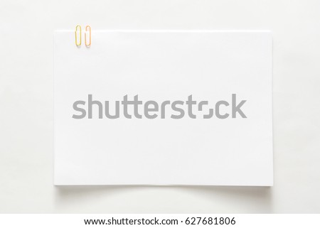 Blank empty sheet of paper attached with clip isolated on white background. Copy space