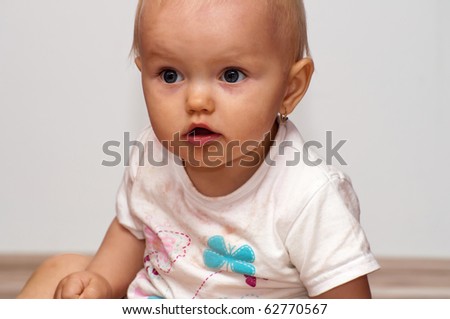 Portrait of cute baby in the interior.