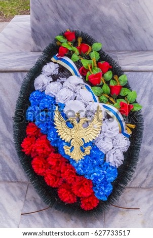 Funeral wreath, colors of the Russian flag, two-headed eagle.
