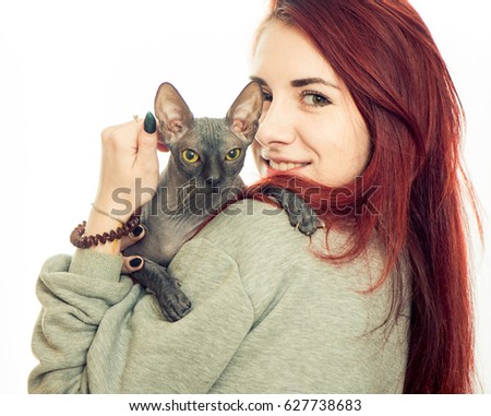 young brunet woman portrait with sphinx cat at white background