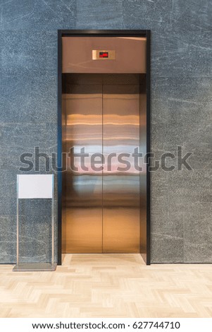 Modern elevator with sign white board blank and gray marble wall