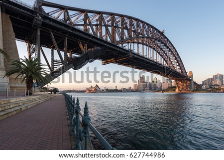 Beautiful sunrise over Opera House and Sydney Harbour Bridge viewed from Kirribilli in North Sydney.