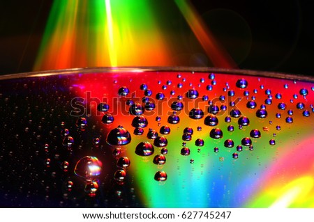 DVD and CD disc with water drops over. Full Colour Background.