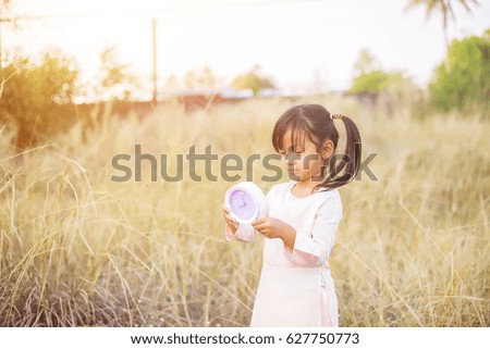 Little nerdy girl in panic holding clock 
