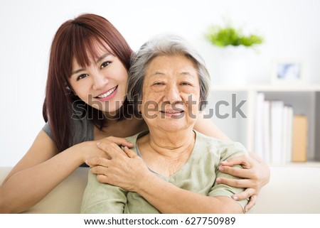 Grandmother and granddaughter. Young woman carefully takes care of old woman Royalty-Free Stock Photo #627750989