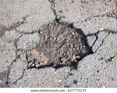 Broken asphalt road