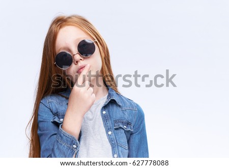 Beauty and fashion girl posing with glasses in front of the camera