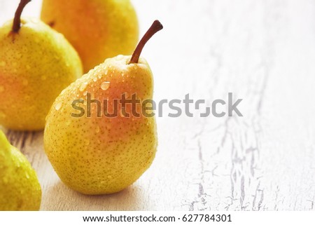 Fresh williams pears (Bartlett pear) on white rustic background. Copy space Royalty-Free Stock Photo #627784301