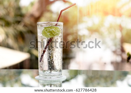Glass of fresh sparkling mineral water and a lime in blur blackground Royalty-Free Stock Photo #627786428