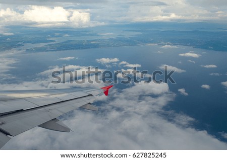 Beautiful Blue Sky Background and White Cloud by Take a Picture Through Window of an Aircraft during Flight in Wing.