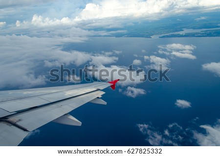 Beautiful Blue Sky Background and White Cloud by Take a Picture Through Window of an Aircraft during Flight in Wing.