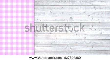 Traditional light grey wooden plank with copy space and tablecloth checkered white and pink