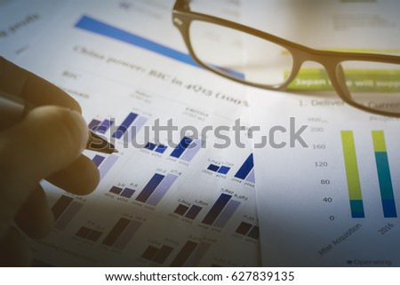 Business analysis with pen and glasses