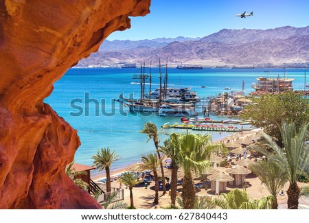 Summer day on the central beach of Eilat - famous international resort city, Israel Royalty-Free Stock Photo #627840443