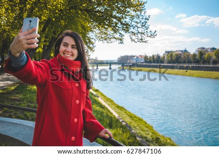 woman talking on the phone while walking blooming sakura on background