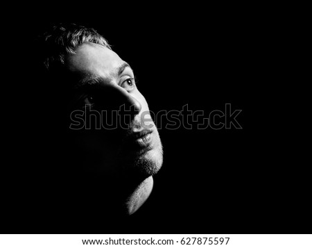 Handsome man portrait. Portrait in profile. Side view on black background