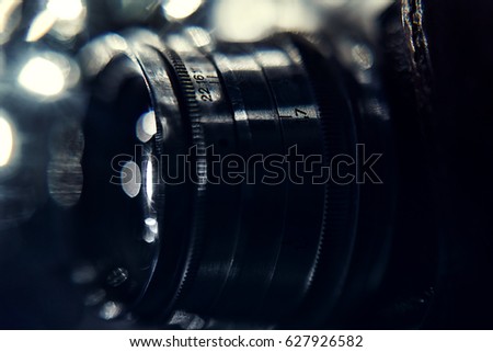 Close up of old camera lens on beautiful bokeh. image is retro filtered. selective focus. Retro photo bokeh background
