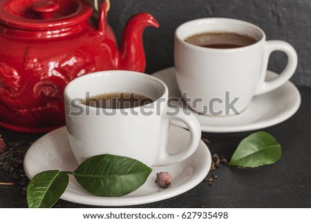 tea concept/tea pot and cups of tea on slate
