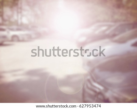 Blured image of cars in parking lot on day time