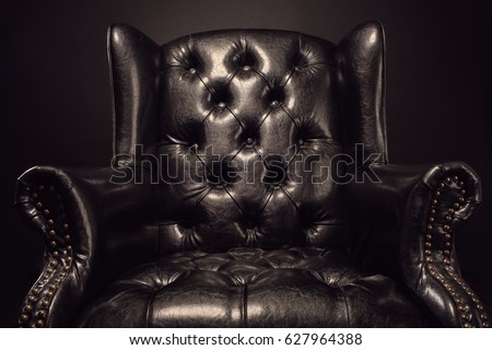 Black vintage leather armchair boss on a black background with w Royalty-Free Stock Photo #627964388