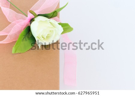 Close up white rose flower on the paper box on the white background,Greeting card for Birthday or Mothers Day