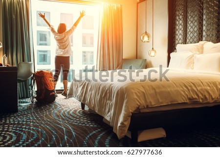 Happy backpacker traveller stay in high quality hotel Royalty-Free Stock Photo #627977636