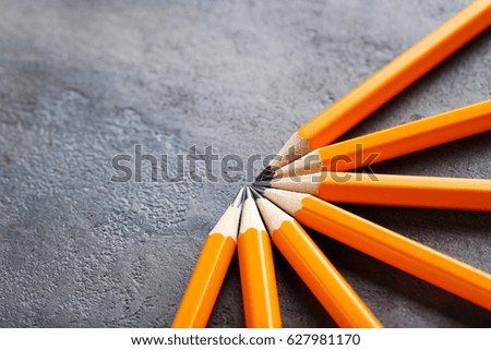 Yellow pencils on grey wooden table