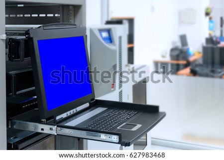 KVM Switch with blue screen monitor in data center room Royalty-Free Stock Photo #627983468