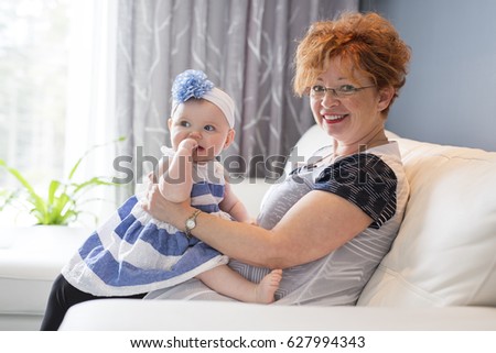 A Grandmother hold little baby girl cute smiling close-up