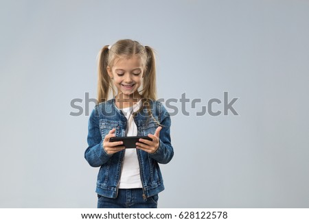 Little Teenage Girl Using Cell Smart Phone, Small Kid Happy Smiling Child Isolated Over Gray Background