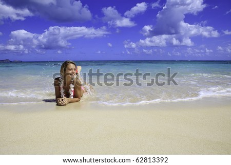 teenage girl in pink bikini at the beach in hawaii