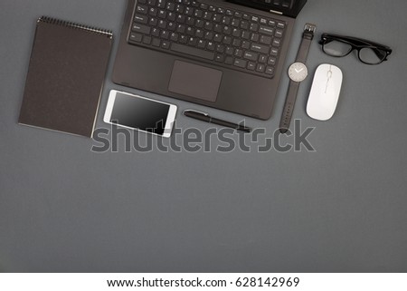 workplace of businessman - laptop, smartphone, glasses and notepad, flat top view