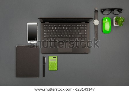 workplace of businessman - laptop, smartphone, glasses and notepad, flat top view
