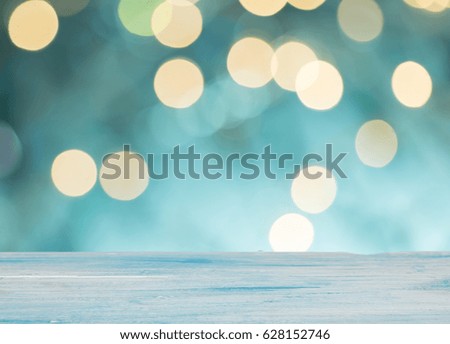 White wooden table in front of bokeh background, for display and montage product for holiday