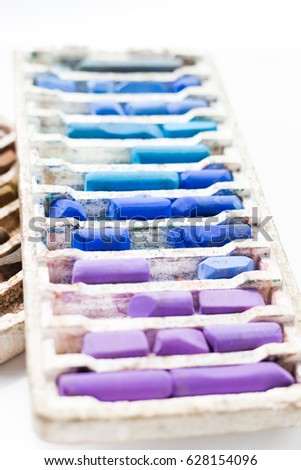 Pastel crayons in box isolated on white background