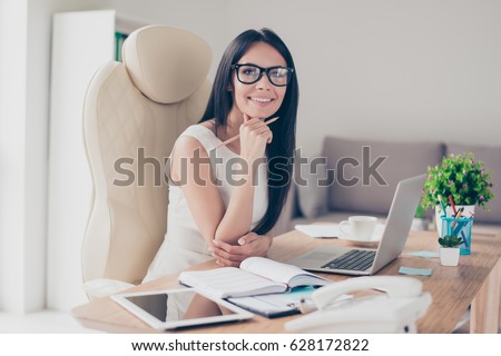 Success conception. Portrait of gorgeous young businesslady in glasses sitting at her workplace in the office Royalty-Free Stock Photo #628172822