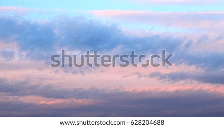 Blue and gray clouds against the blue sky at sunset