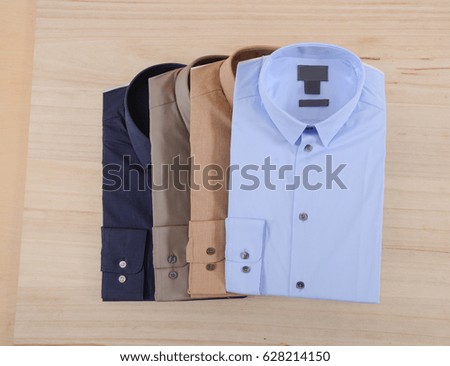 Four man shirt on wooden background