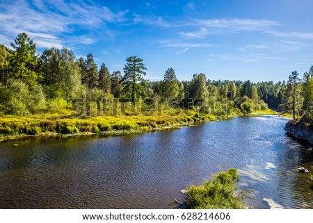 Journey on foot through uncharted roads of a national Park. Summer in the forest. Panorama of the natural landscape. The bend of the river and wild nature of Russia. Blue sky.