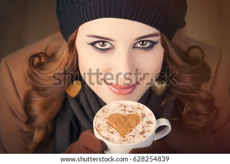 portrait of beautiful young woman with cup of coffee on the wonderful grey studio background