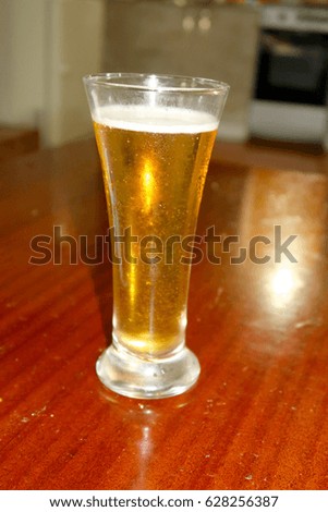 A glass of beer with drops